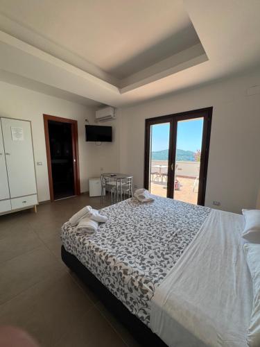 a bedroom with a bed and a view of the beach at B&B Villa Setharè in Salerno