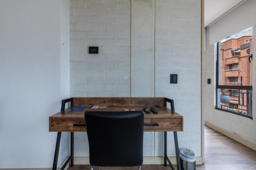 a desk in a room with a black chair at Terra Biohotel in Medellín
