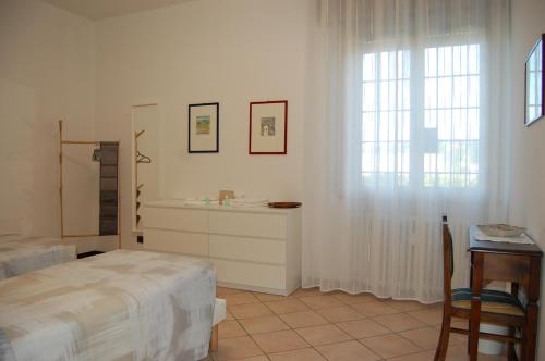 a bedroom with a bed and a sink and a window at Ca Nora in Sasso Marconi