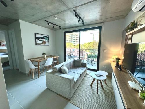 a living room with a couch and a table at First del Sol in Asuncion