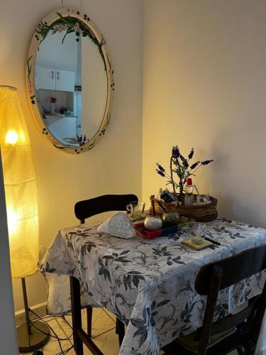 a table in a room with a round mirror at Los Lapachos in San Miguel de Tucumán