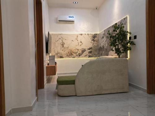 a living room with a couch and a wall at KeeT luxurioushomes in Ikota