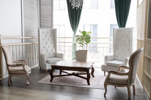 a living room with two chairs and a coffee table at Hotel Du Parc in Medellín
