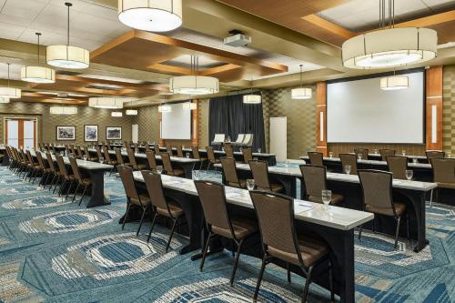 a conference room with a long table and chairs at SpringHill Suites by Marriott Deadwood in Deadwood