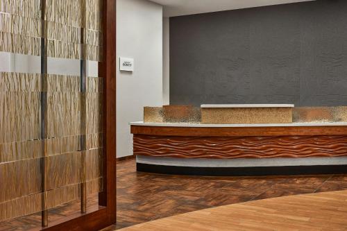 a lobby with a reception desk and a wall at SpringHill Suites by Marriott Deadwood in Deadwood