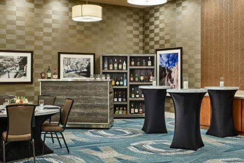 a restaurant with tables and bottles of wine at SpringHill Suites by Marriott Deadwood in Deadwood