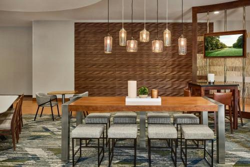 a dining room with a table and chairs at SpringHill Suites by Marriott Deadwood in Deadwood