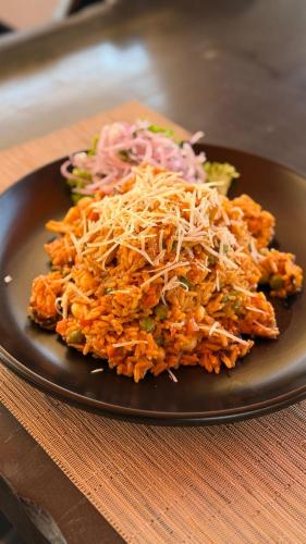 a plate of food with rice and vegetables on a table at ÓRGANOS BEACH bungalows & suites in Los Órganos