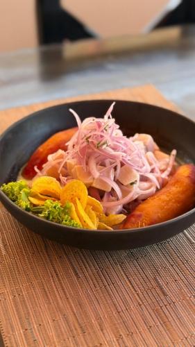 a pan filled with food on a table at ÓRGANOS BEACH bungalows & suites in Los Órganos