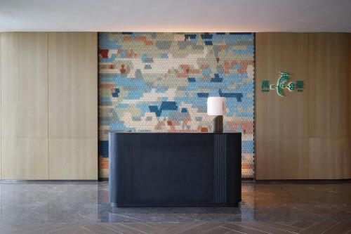 a lobby with a table with a lamp on it at Beihai Marriott Resort in Beihai