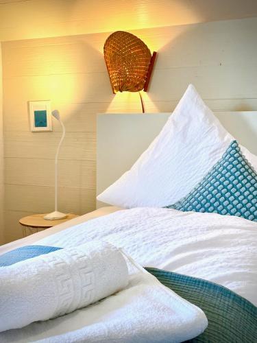 a bedroom with a bed with a pillow and a lamp at Sonnes Apartment in Andelsbuch