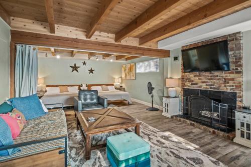a living room with a fireplace and a tv at MtnCity Views 4BR Firepit FamilyRetreat NearUNR in Reno
