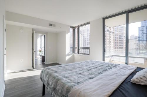 a bedroom with a large bed and large windows at Pentagon Luxe Apartments Arlington - Near DC in Arlington