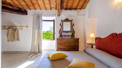 a bedroom with a bed and a mirror and a window at Villa Denise in Mancini