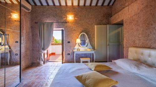 a bedroom with a large bed and a mirror at Villa Denise in Mancini