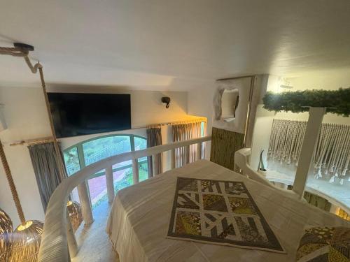a bedroom with a bed and a large window at Flores Gardan ART Studio in Chernomorets