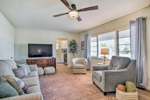 a living room with two couches and a flat screen tv at Centrally Located Tucson Home about 5 Mi to Dtwn! in Tucson