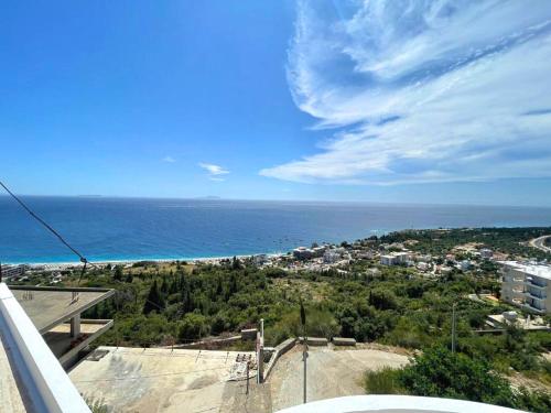 a view of the ocean from a balcony at Endless blue Apartments in Dhërmi