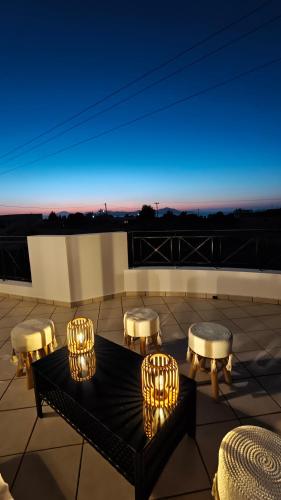 a rooftop patio with a table and chairs and lights at Villa Aphrodity in Kos Town