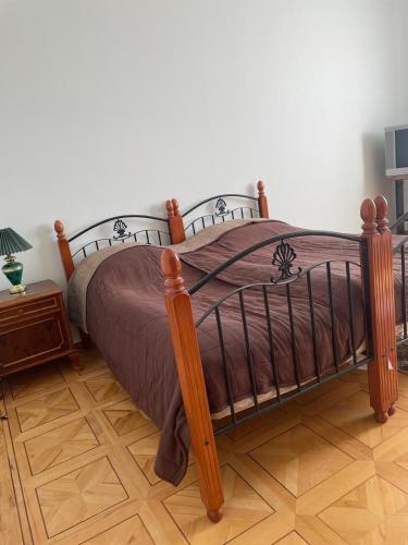 a bedroom with a bed with a wooden frame at Lernarot Guest House in Lernarot