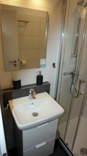 a bathroom with a sink and a shower at Gästehaus Mira in Winterberg