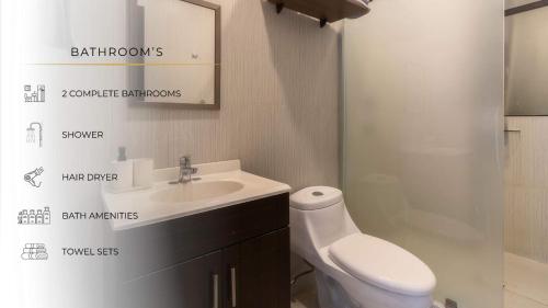 a white bathroom with a sink and a toilet at 206 Zocalo Cathedral 2Bdrm 2Bath apt AC Rooftop in Mexico City