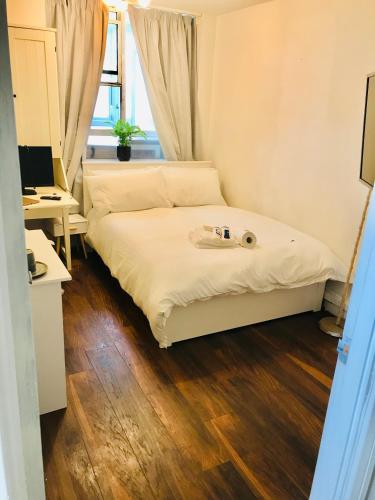 a bedroom with a bed and a desk with a computer at The Willow Room Central Location in Jesmond