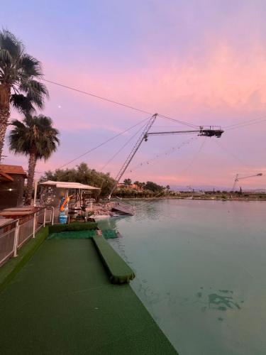 a boat is docked on a river with a crane at Waky Marrakech Villa in El Rhechat
