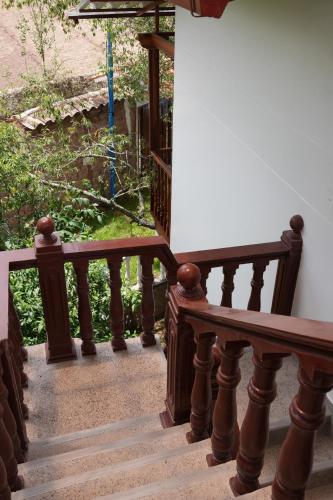 a stairway with a wooden railing and a white board at Casa de campo Asikuy House in Urubamba