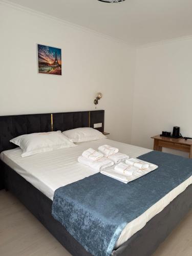 a bed with two white towels on top of it at Турист in Astana