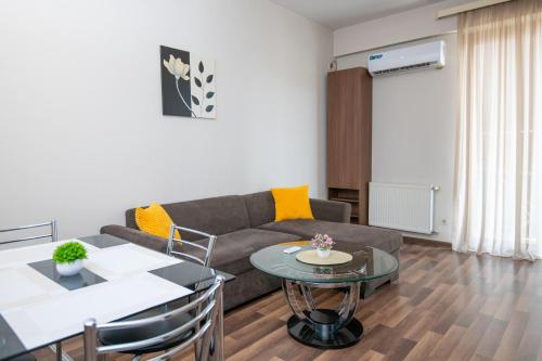 a living room with a couch and a table at Cozy stay rentals- cozy & sweet 1 BR apartment in Tbilisi with city & mountains view in Tbilisi City