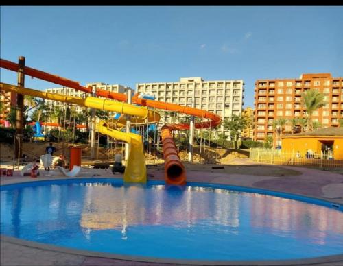 an empty water park with a roller coaster at بورتو جولف in El Alamein