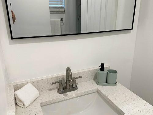 a sink in a bathroom with a mirror and a sink at Family vacation Villa in Fantasy World Resort - Minutes from Disney in Kissimmee