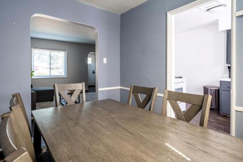 a dining room with a wooden table and chairs at Cozy 2BR Retreat with Workspace - Washer and Dryer in Kettering