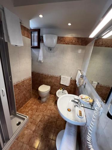a bathroom with a sink and a toilet at CASA DEL SOLE Accomodation in Tropea