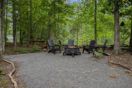 a group of chairs and a fire pit in the woods at Top of the Mountain Breathtaking Views Hot Tub in Blue Ridge