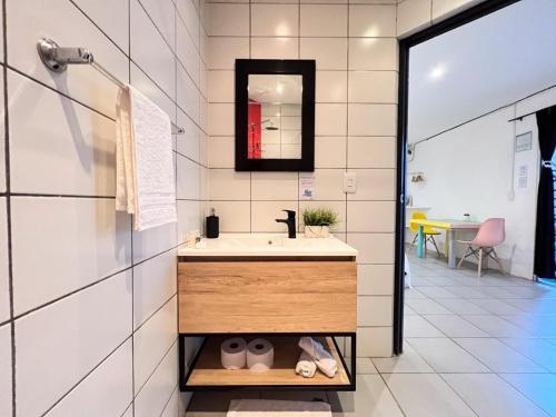 a bathroom with a sink and a mirror at Ocean Lovers Taganga - PADI Dive Center & Hostel in Taganga