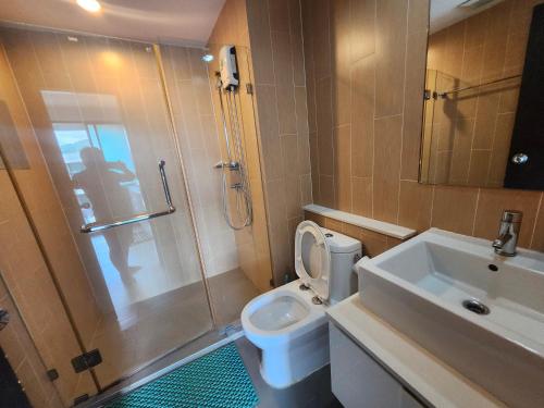 a bathroom with a toilet and a shower and a sink at centrio Condominium 8159 in Ban Rangeng