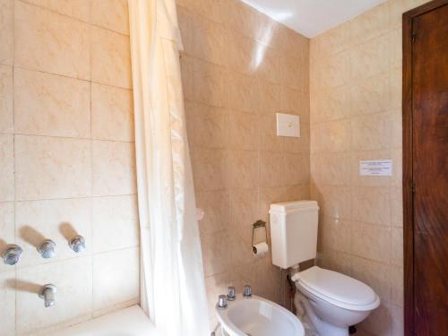 a bathroom with a toilet and a sink and a shower at Cabañas Rio Hermoso in Cerro Negro