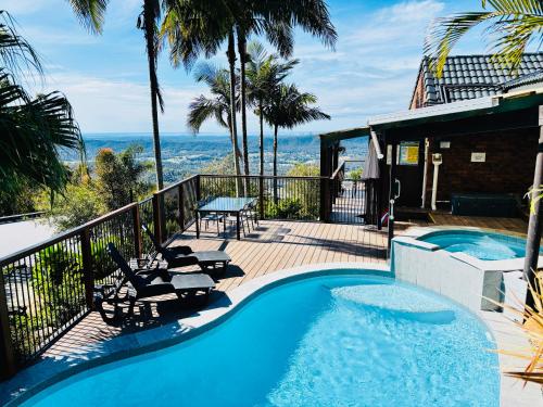 a pool on a deck with a view of the ocean at The Hillside Retreat in Mount Tamborine