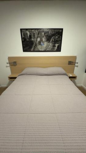 a bedroom with a bed with a white bedspread at Cilveti 468 departamento con cochera, excelente ubicación in Rosario
