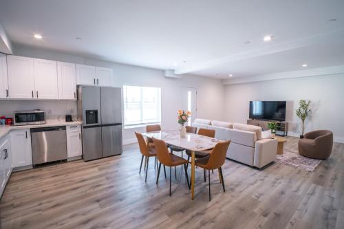 a kitchen and living room with a table and chairs at Modern 2BR2BA Home Near USC Walk to Campus in Los Angeles
