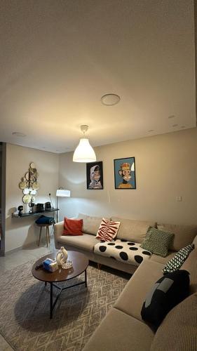 a living room with a couch and a table at شقة غرفة وصالة in Al Khobar