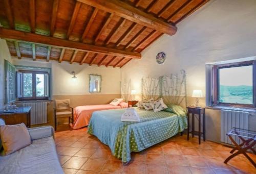 a bedroom with a bed and a couch at Il Poggio al Sole in Fiesole