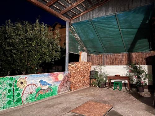 a building with a painting on the side of it at Loza House in Arandjelovac
