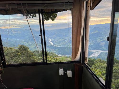 a view from a window in a room with mountains at Casa en el árbol en Titiribi in Titiribí
