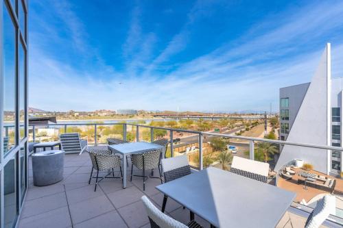 a balcony with tables and chairs on a building at Olive Oasis Retreat - Walkout to Pool & Hot Tub! in Tempe Junction
