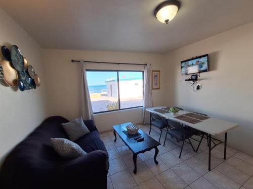 a living room with a couch and a table at #55 Suite Bungalow Seaside Hotel & Victors RV Park in San Felipe