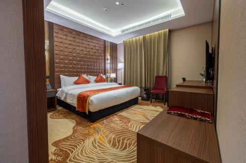 a hotel room with a bed and a television at فندق الترحيب Atarheeb Hotel in Tabuk