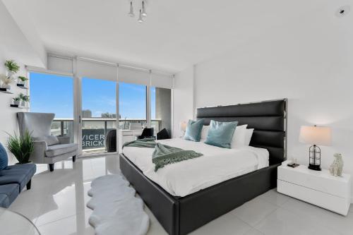 a bedroom with a large bed and a chair at Luxury Unit W Residences Brickell in Miami
